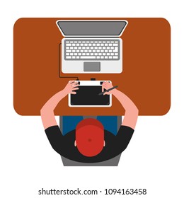 designer working on laptop using pen tablet top view