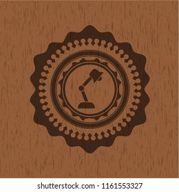 desk lamp icon inside badge with wood background
