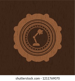 desk lamp icon inside badge with wood background