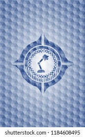 desk lamp icon inside blue hexagon badge.