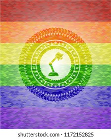 desk lamp icon inside emblem on mosaic background with the colors of the LGBT flag