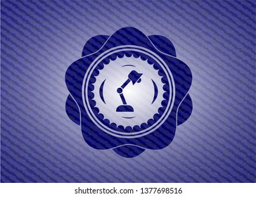 desk lamp icon inside emblem with jean background