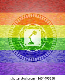 desk lamp icon inside emblem on mosaic background with the colors of the LGBT flag