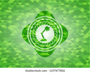 desk lamp icon inside green emblem. Mosaic background
