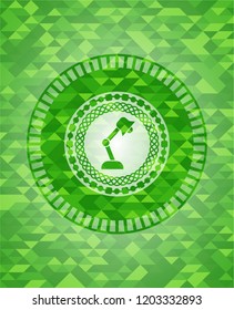 desk lamp icon inside green emblem with mosaic ecological style background