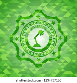 desk lamp icon inside green emblem. Mosaic background