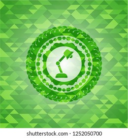 desk lamp icon inside green emblem with mosaic ecological style background
