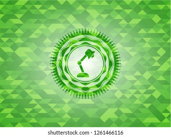 desk lamp icon inside green mosaic emblem