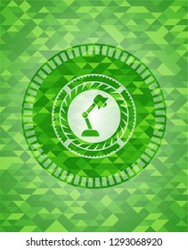 desk lamp icon inside green emblem with mosaic background