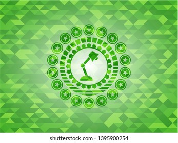 desk lamp icon inside green emblem with triangle mosaic background