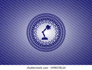 desk lamp icon inside jean background. 