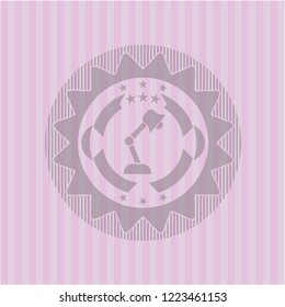 desk lamp icon inside pink emblem