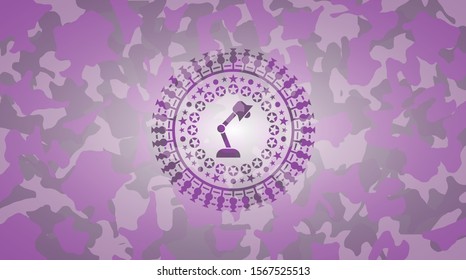 desk lamp icon inside pink and purple camouflage emblem