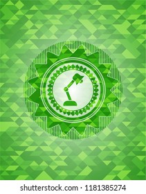 desk lamp icon inside realistic green emblem. Mosaic background