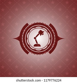 desk lamp icon inside red icon or emblem