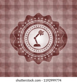 desk lamp icon inside red seamless badge with geometric pattern.
