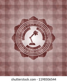 desk lamp icon inside red seamless geometric badge.