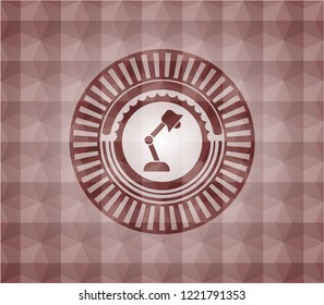 desk lamp icon inside red seamless geometric emblem.