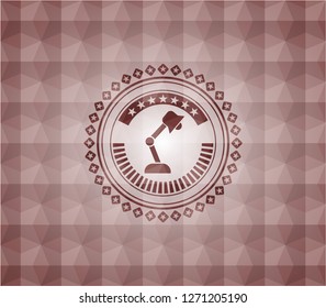 desk lamp icon inside red seamless polygonal badge.