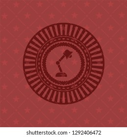 desk lamp icon inside red icon or emblem