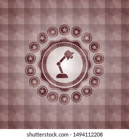 desk lamp icon inside red seamless emblem or badge with abstract geometric polygonal pattern background.
