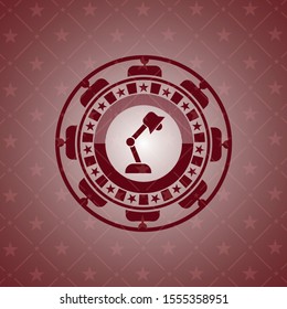 desk lamp icon inside red emblem