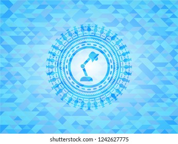 desk lamp icon inside sky blue emblem with mosaic background