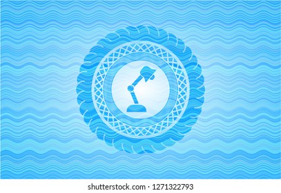 desk lamp icon inside water wave concept emblem background.