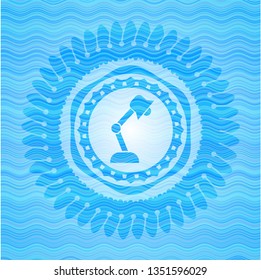 desk lamp icon inside water emblem background.
