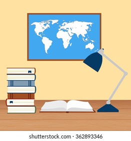 desk with lamp and stack of books against the background of the world map