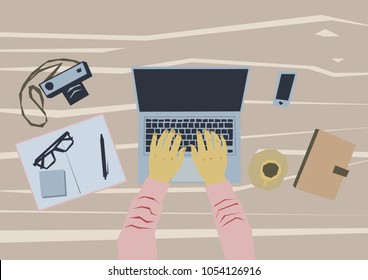 Desk with a laptop, notebook, smartphone and camera. Top view.