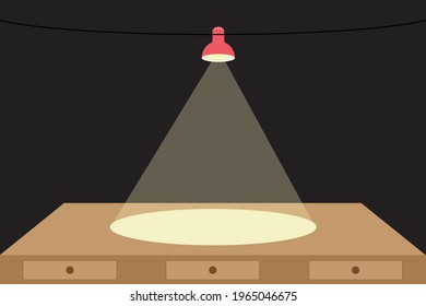 Desk office with light from a lamp shining on a black background