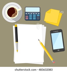 Desk at Work Place With Coffee And A Calculator Next to Sheets of White Paper