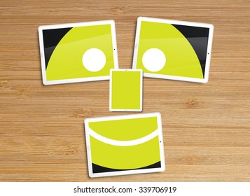 Desktop with tablets and a smiley, vector illustration