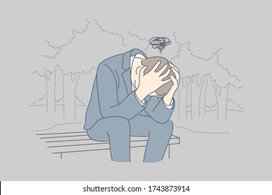 Despair, frustration, depression, business concept. Desperate young businessman crying in his hands sitting on bench covering head. Fatigue headache or migraine bad news and raising of mental stress.