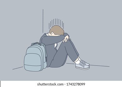 Despair, frustration, depression, mental stress, bullying concept. Young desperate frustrated depressed child schoolboy sitting in corner crying. Negative emotions headache or migraine and bad news.