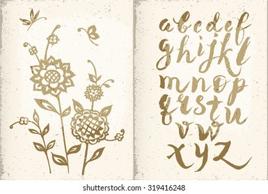 A detailed book with an old vintage paper with handwritten alphabet and pattern of sunflowers and butterflies, painted with gold paint.