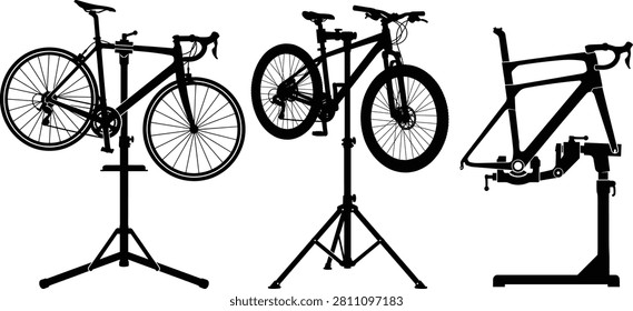 A detailed set of vector silhouettes featuring a road bike, mountain bike, and bicycle frame mounted on professional mechanics' repair stands. This graphic asset is perfect for bike shop branding, bicycle repair services, maintenance manuals, and cycling community promotions.