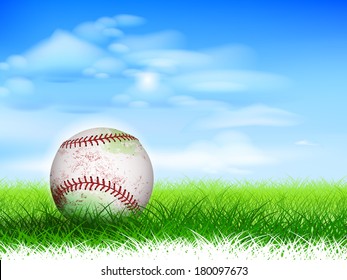 Detailed used baseball on lush grassy field.