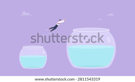 Determination or new challenge concept, confident businessman jump from small fishbowl to the better one. Change or move to better opportunity, entrepreneurship, escape from comfort zone or safe zone.