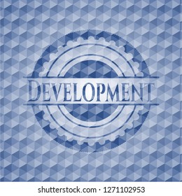 Development blue emblem or badge with abstract geometric pattern background.