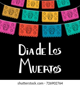 Dia de Los Muertos, Mexican Day of the Dead card, invitation. Party decoration, string of lights, handmade cut paper flags, skull, floral decor. Old wooden background.