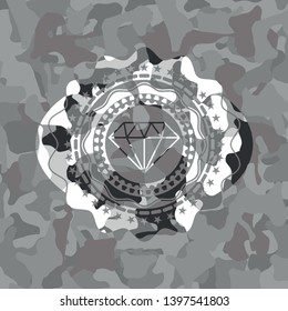 diamond icon inside grey camouflaged emblem