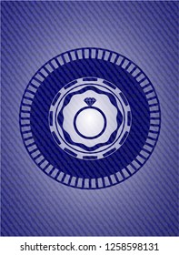 diamond ring icon inside badge with denim background