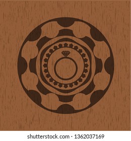 diamond ring icon inside badge with wood background