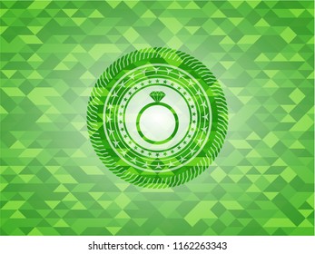 diamond ring icon inside green emblem. Mosaic background