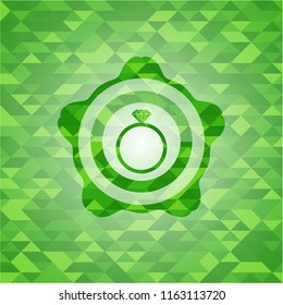 diamond ring icon inside green emblem with triangle mosaic background