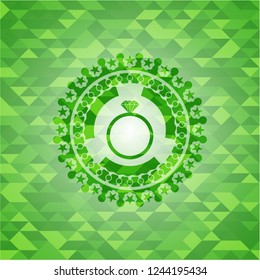diamond ring icon inside green emblem with mosaic background