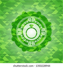 diamond ring icon inside green emblem with mosaic background