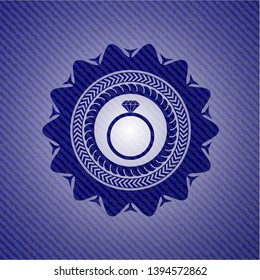 diamond ring icon inside jean or denim emblem or badge background